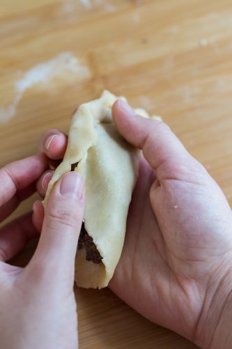 Folding edges of a homemade empanada.