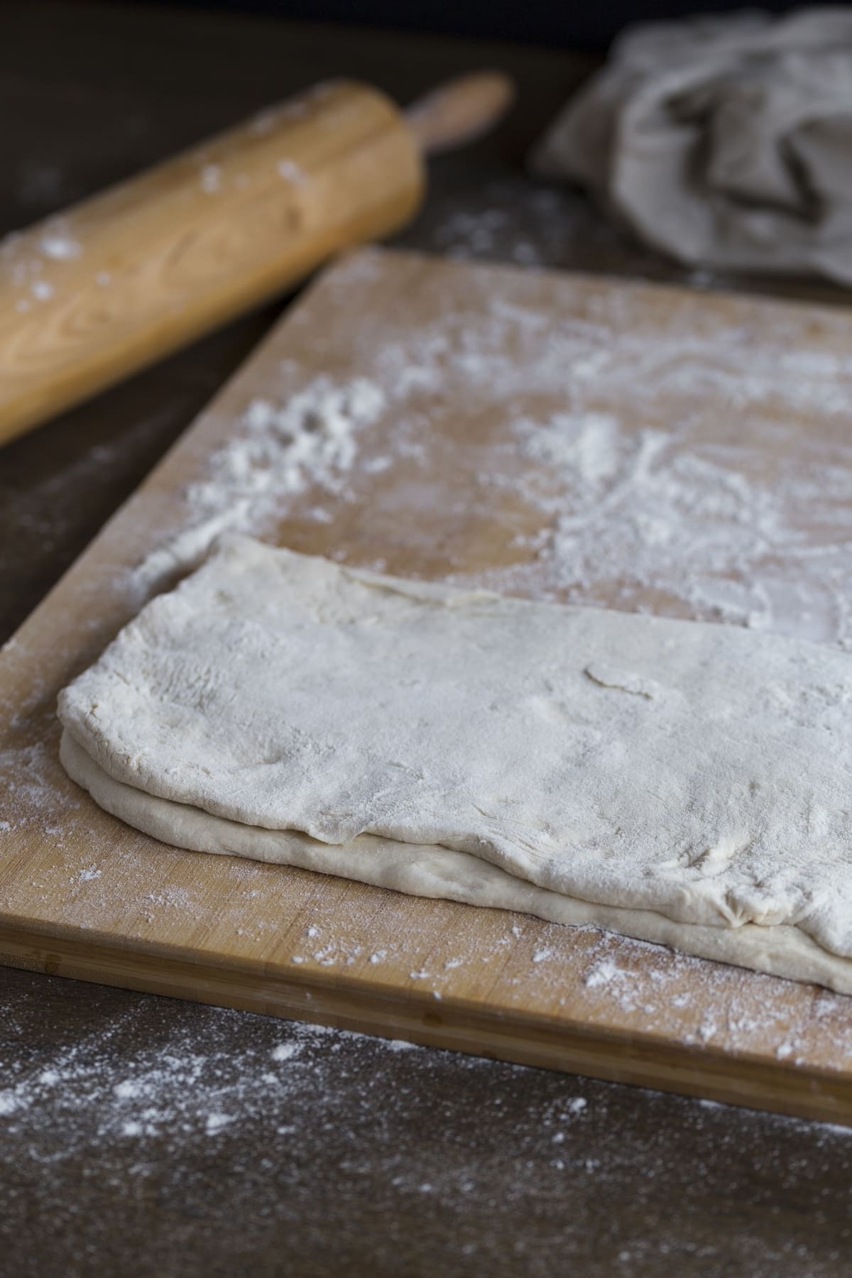 Dough folded on a wooden surface.