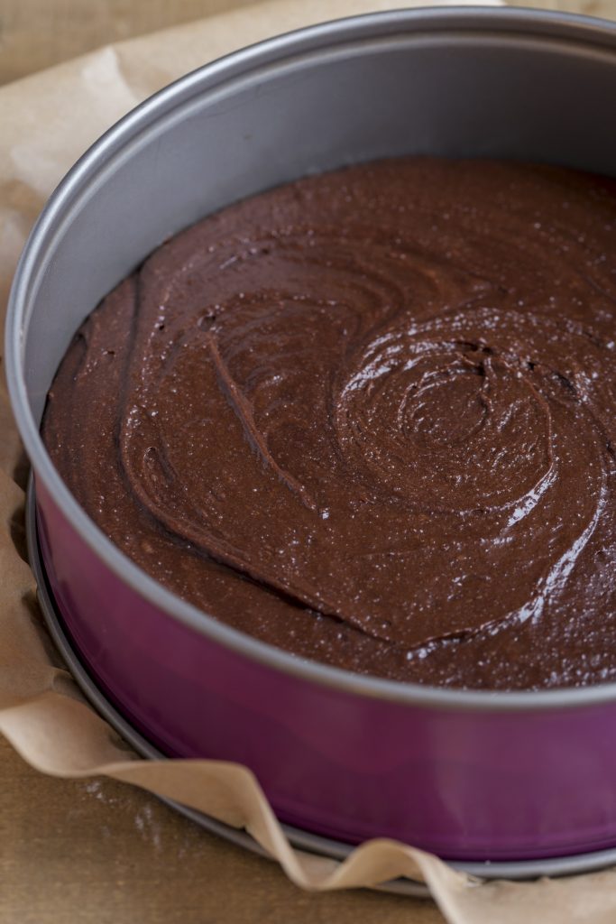 Chocolate cake batter in a springform pan.