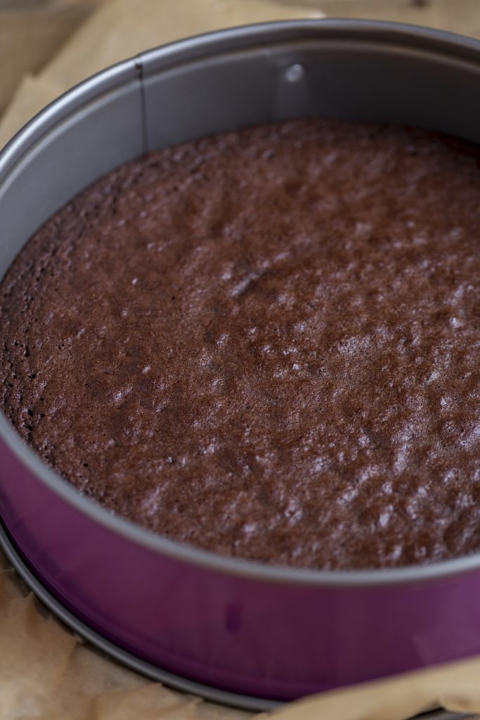 Baked kladdkaka resting and setting in the pan.