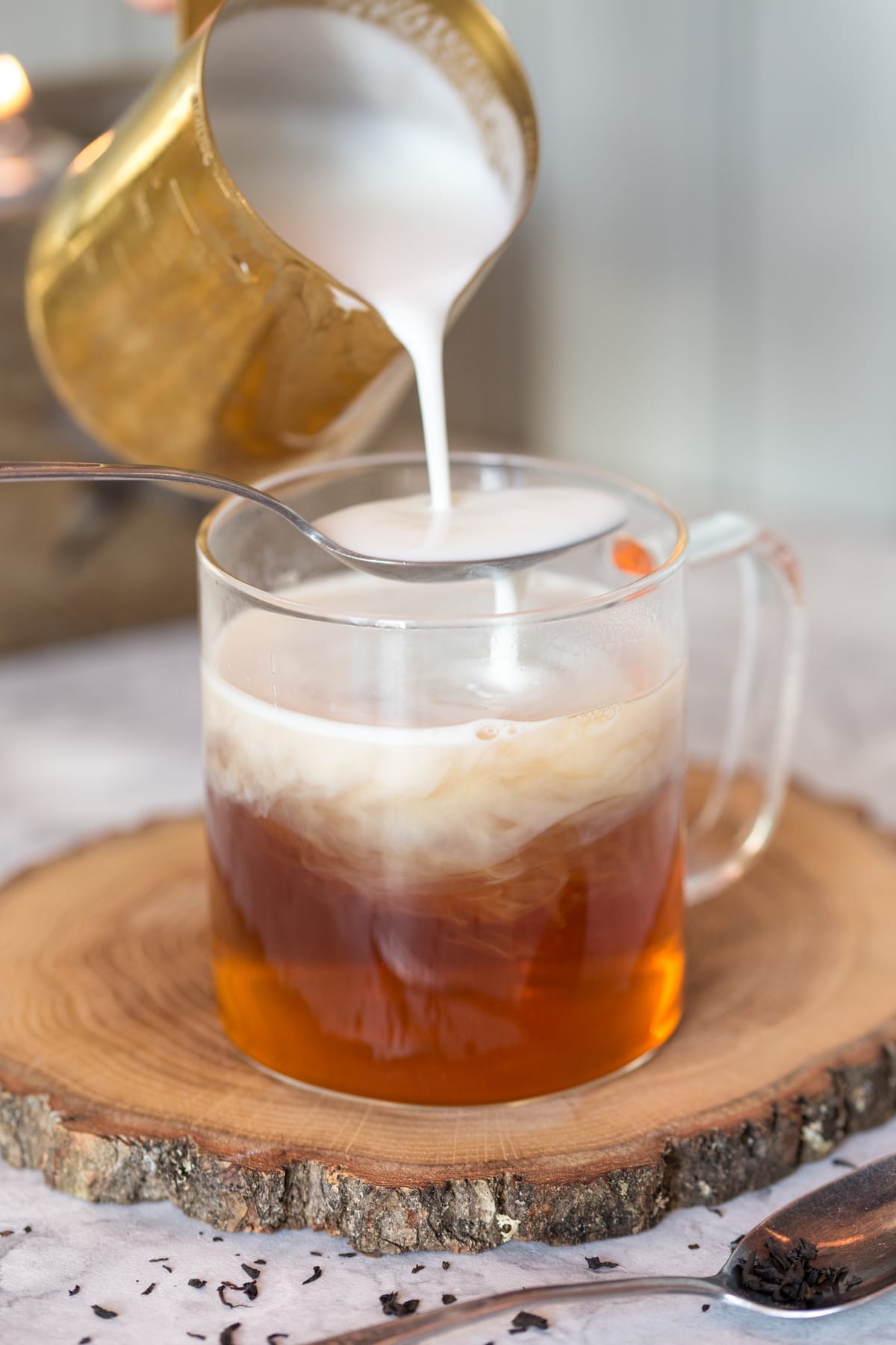 Adding steamed milk to tea.