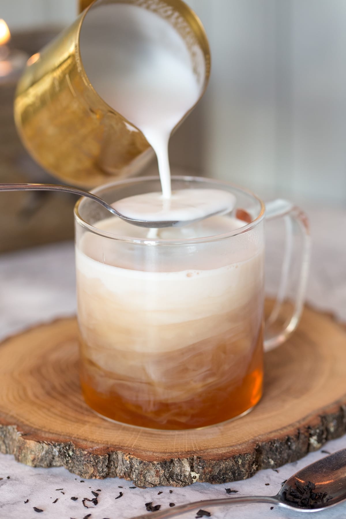 Adding steamed milk to tea.