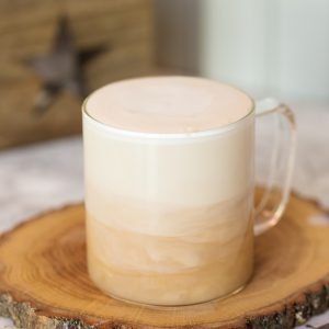 London fog tea latte in a glass mug showing the milk layering over the tea.