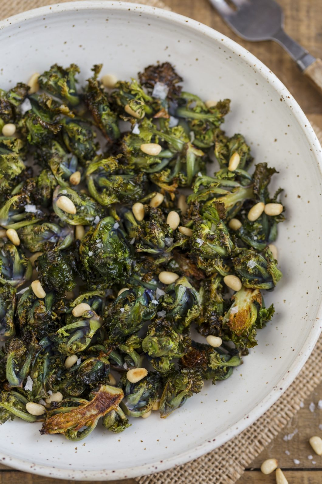 Closeup of roasted flower sprouts with pine nuts.