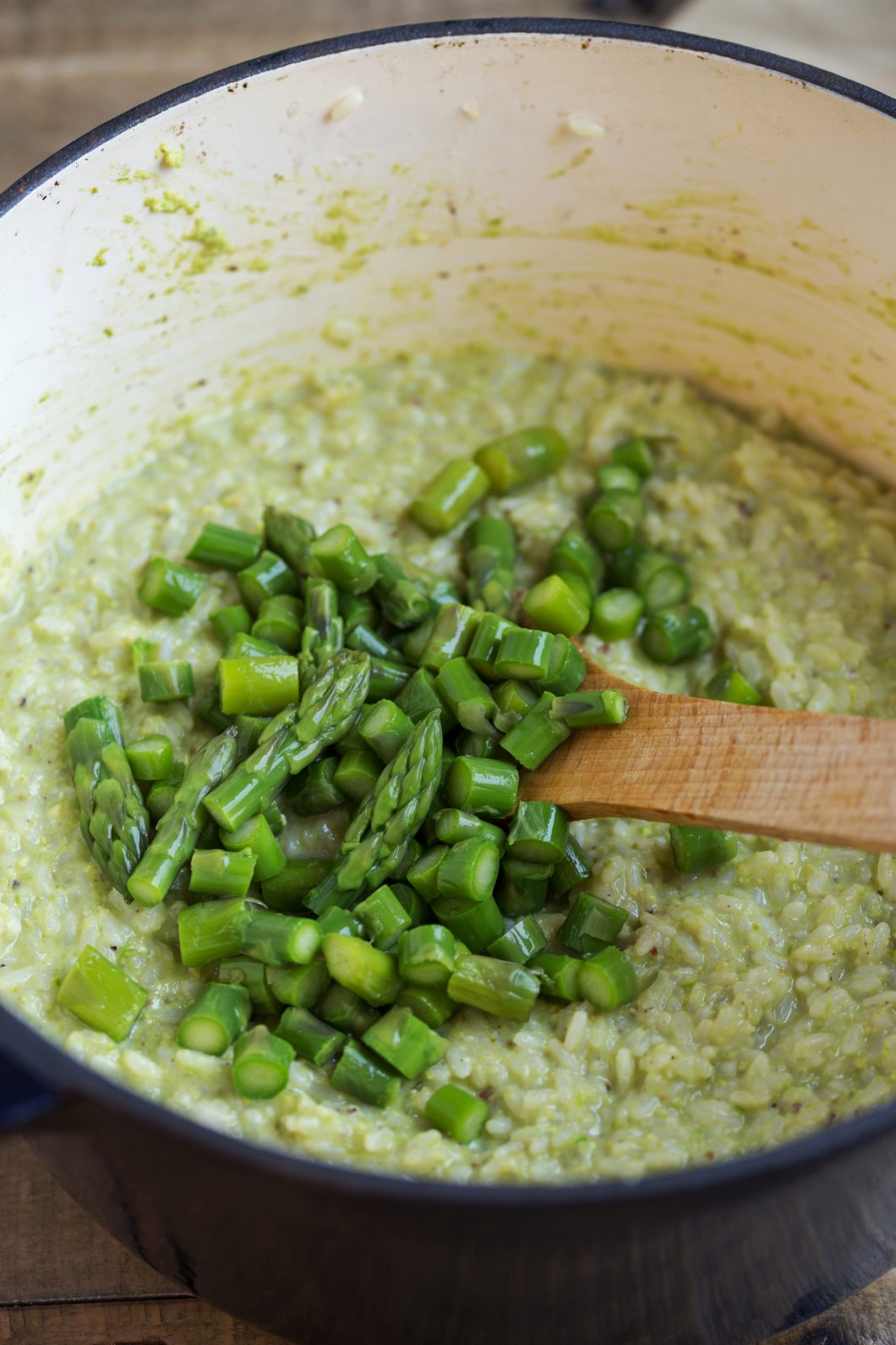 Chopped asparagus added to the risotto pot.