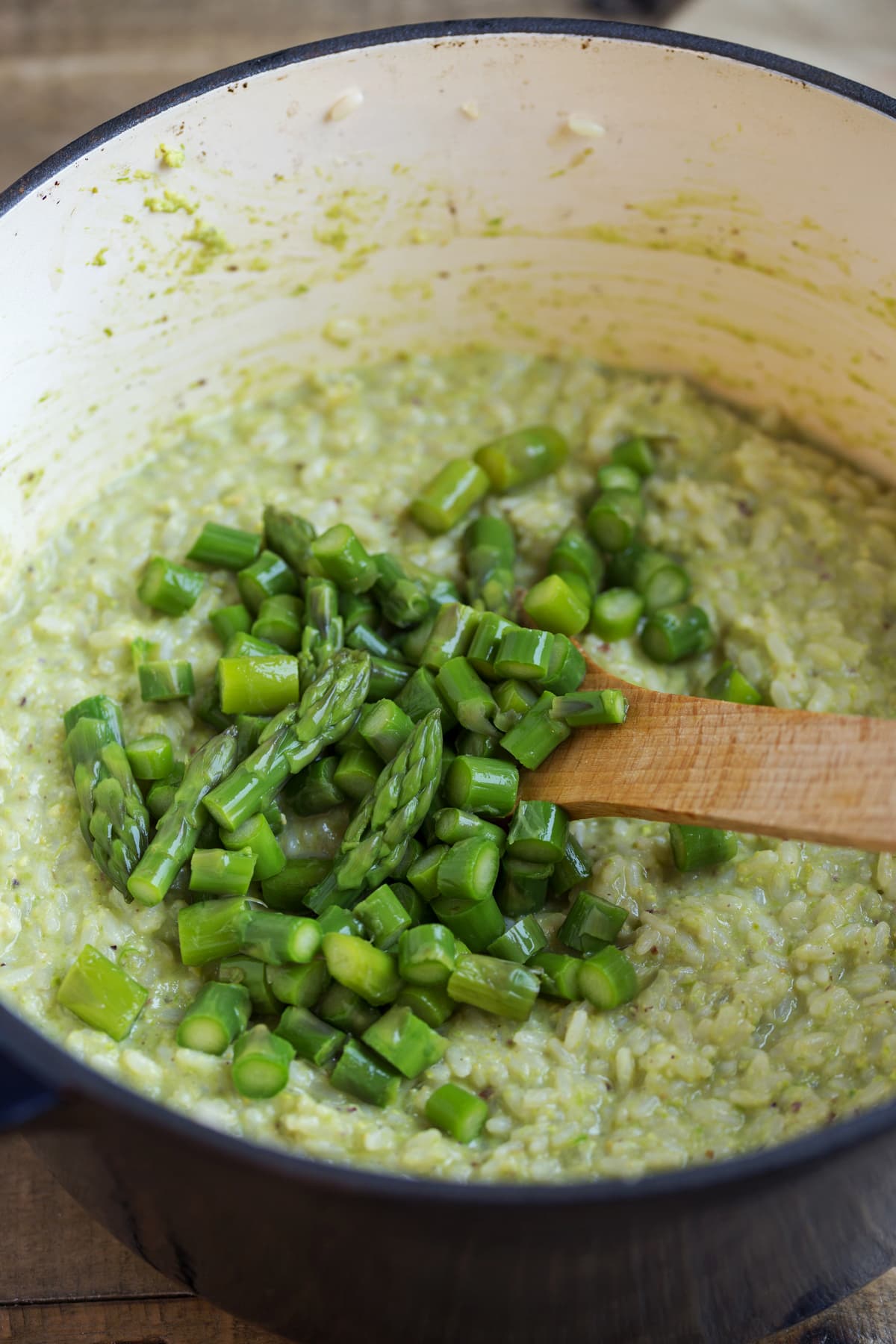 Chopped asparagus added to the risotto pot.