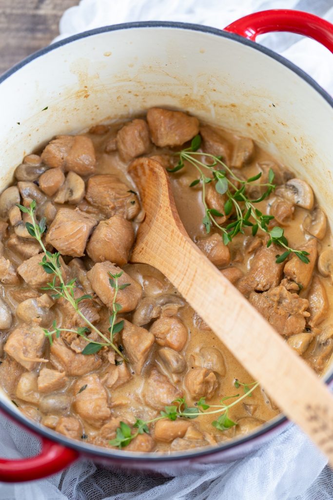 Overhead view of chicken cream cheese stew in a Dutch oven.