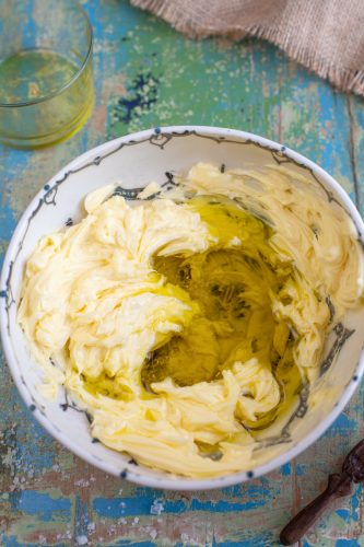 Olive oil mixed with butter in a white bowl.