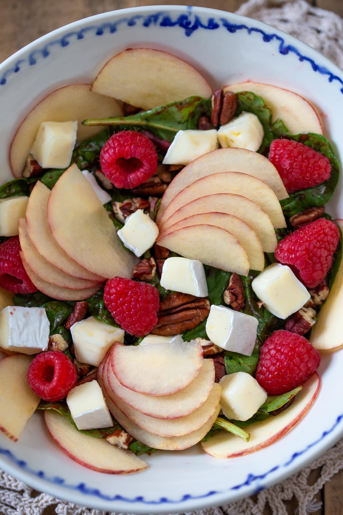 Apple salad on spinach leaves.