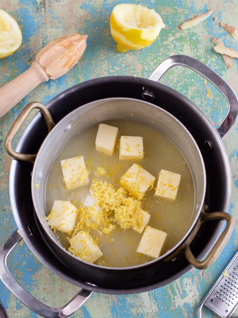 The ingredients to make ginger lemon curd on a double boiler.