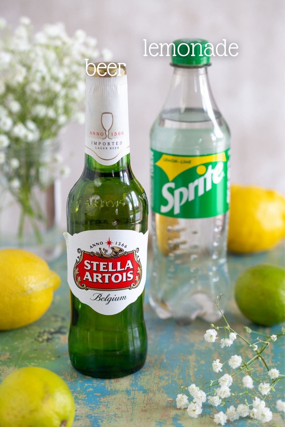 A bottle of lager beer and a bottle of Sprite lemonade.