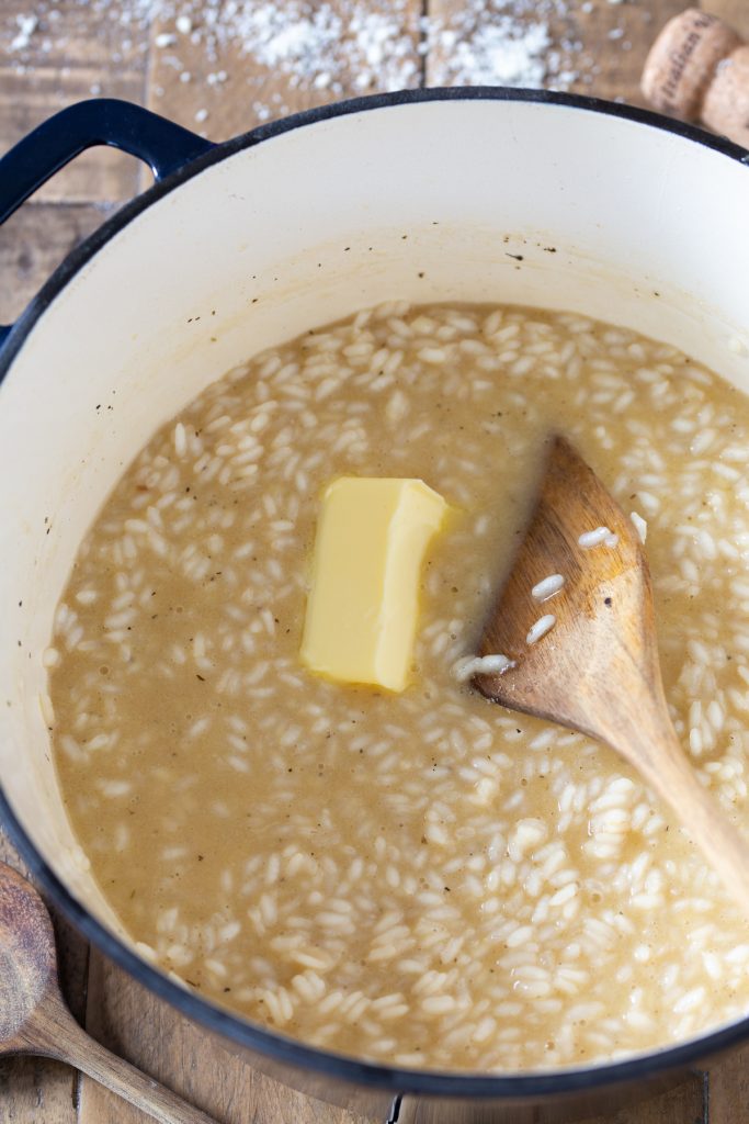 Adding butter to risotto.