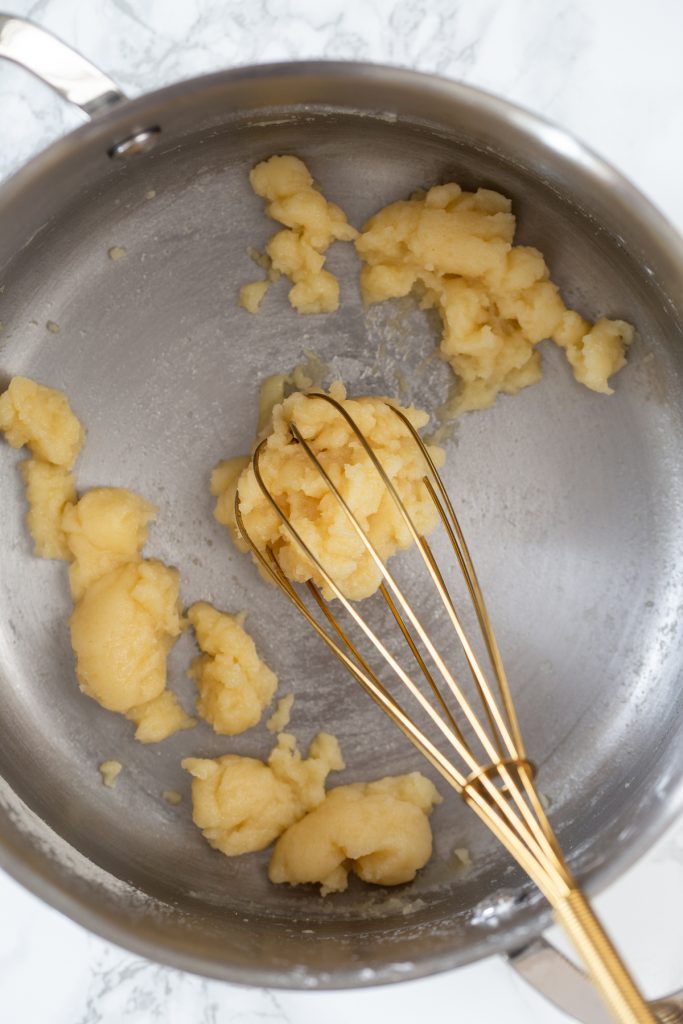 Whisking the choux pastry batter.