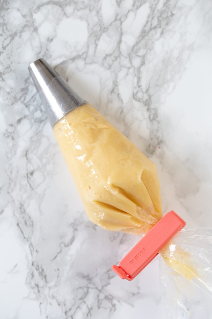 Choux batter in a piping bag.