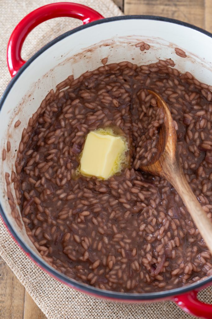 Adding butter to the risotto.