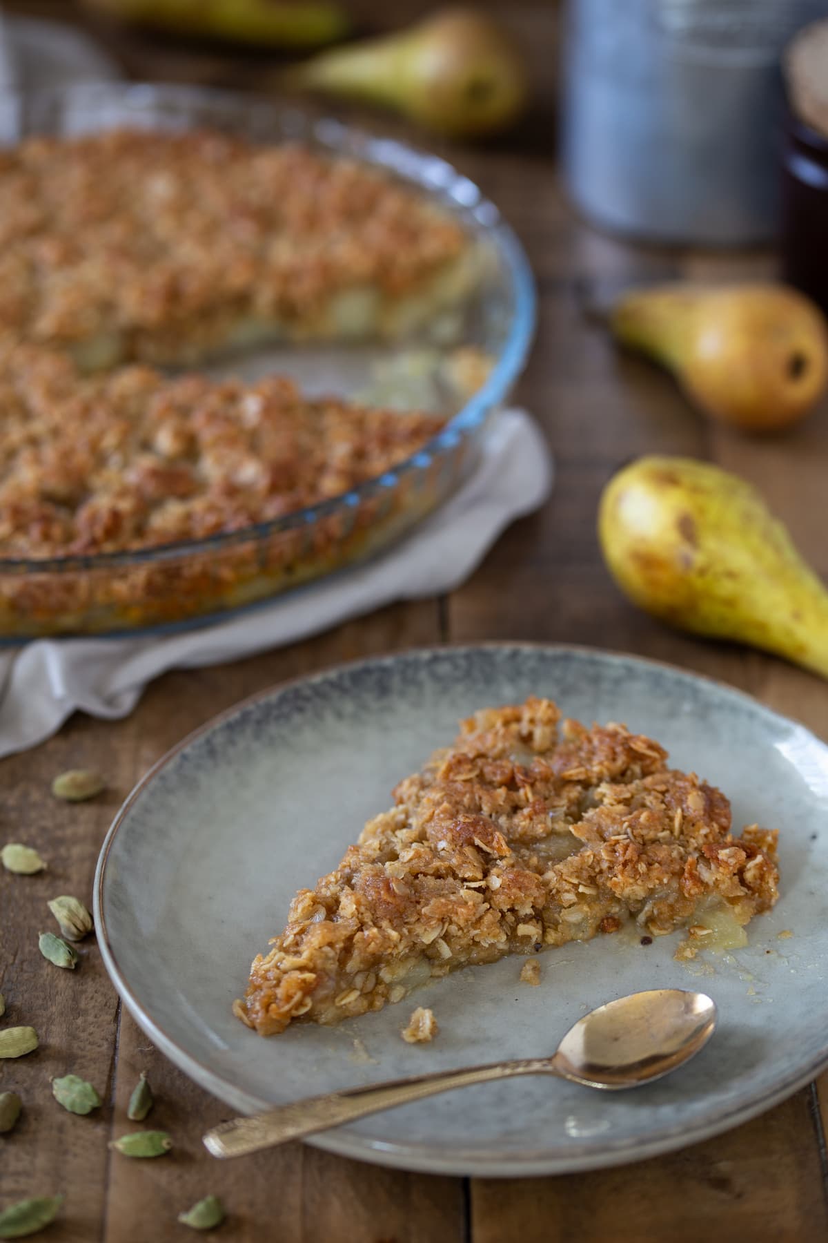 A slice of pear crisp on a beige plate.