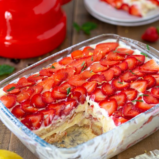 Strawberry limoncello tiramisu with one portion missing.