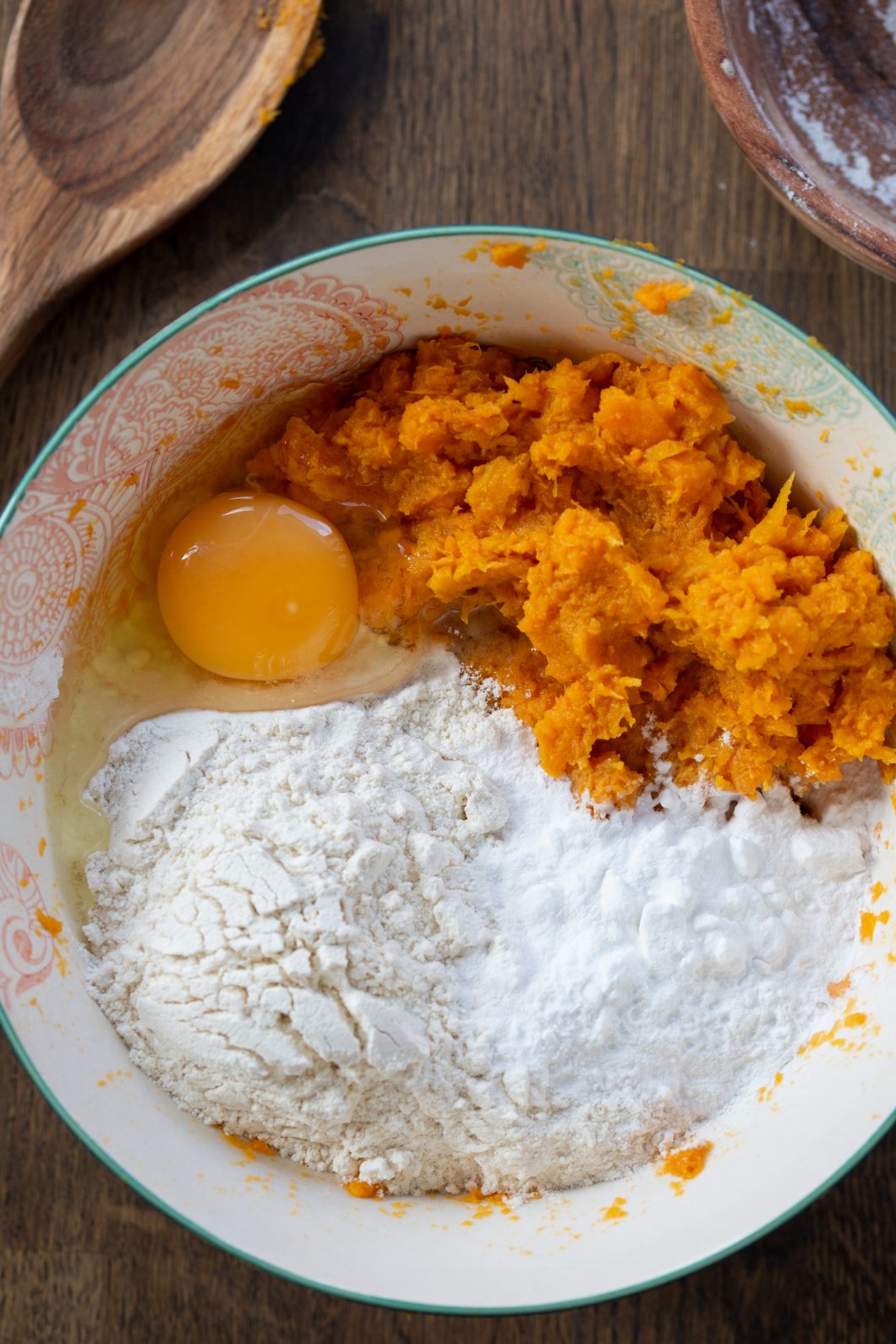 Mashed sweet potatoes in a bowl with flour, starch and egg.