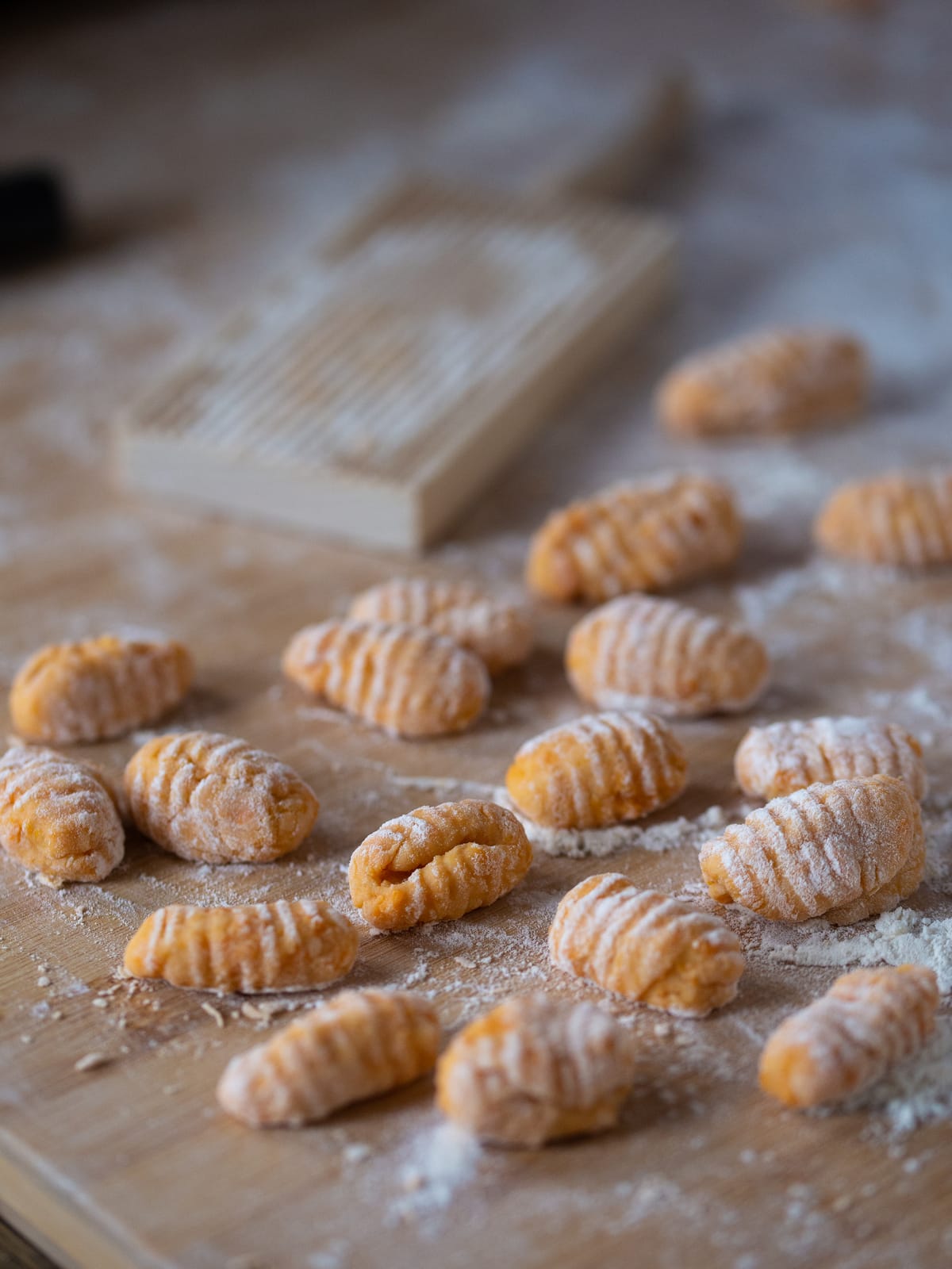 Fresh gnocchi that have been pressed onto a gnocchi board to create little ridges.