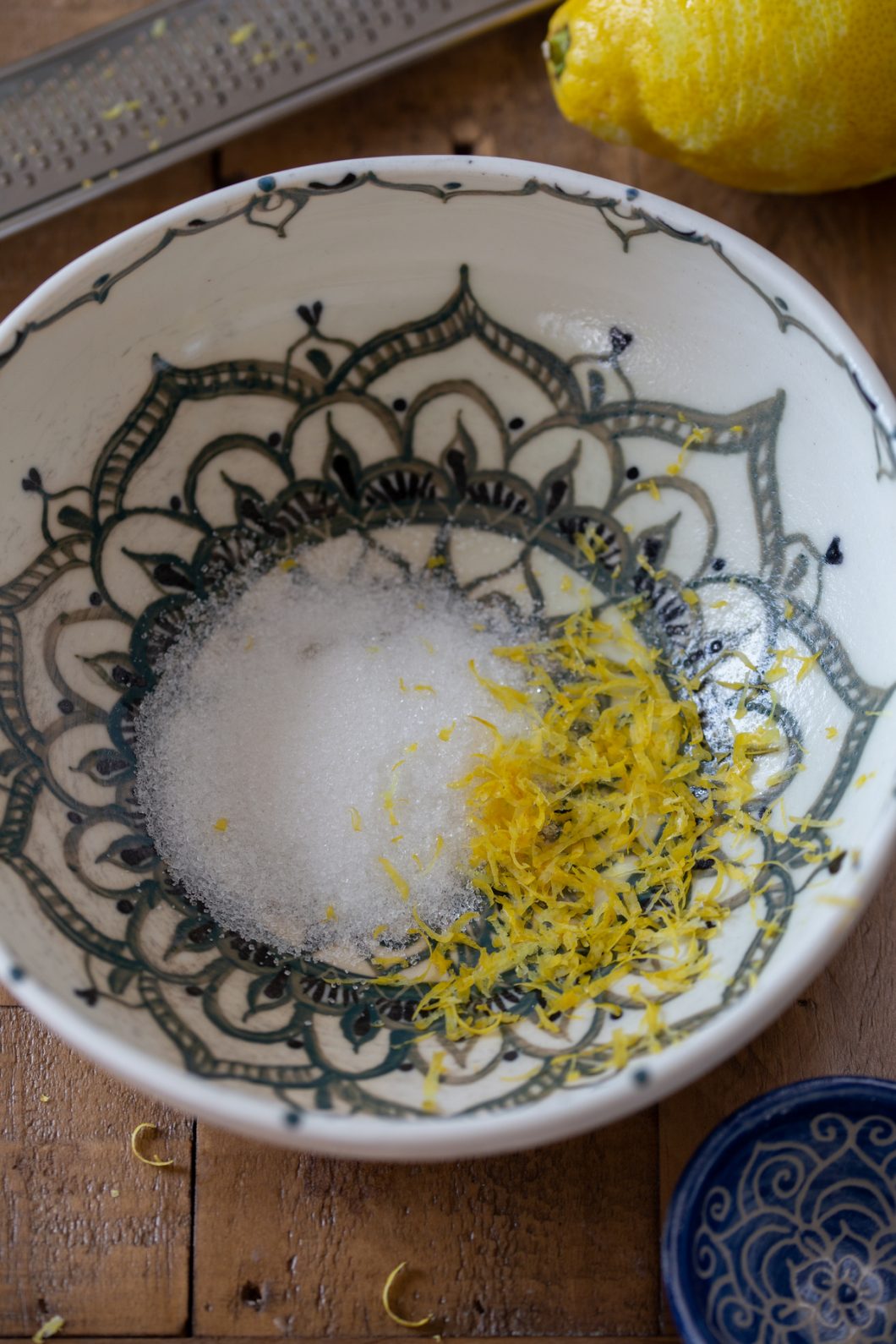 Mandala bowl with granulated sugar and lemon zest.