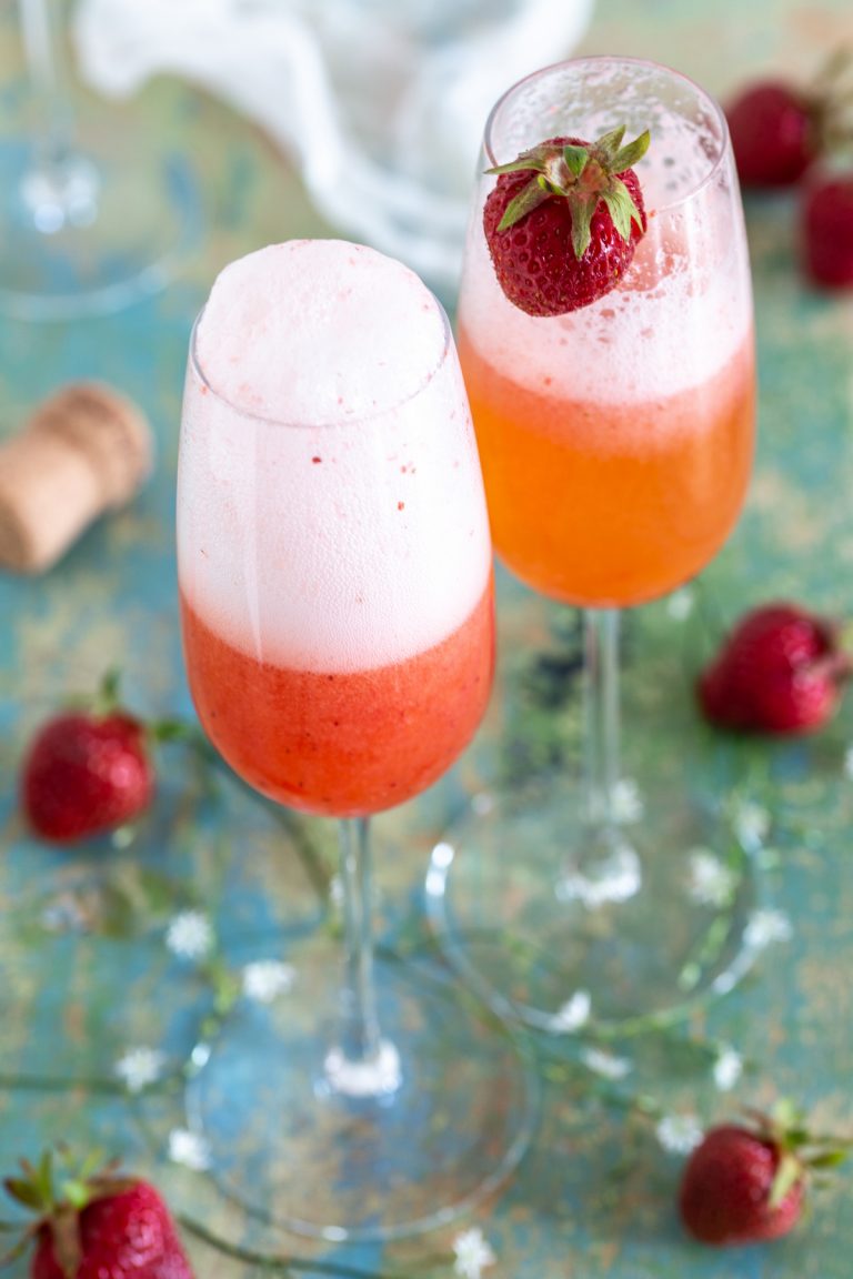Strawberry rhubarb bellini with a fresh strawberry on top.