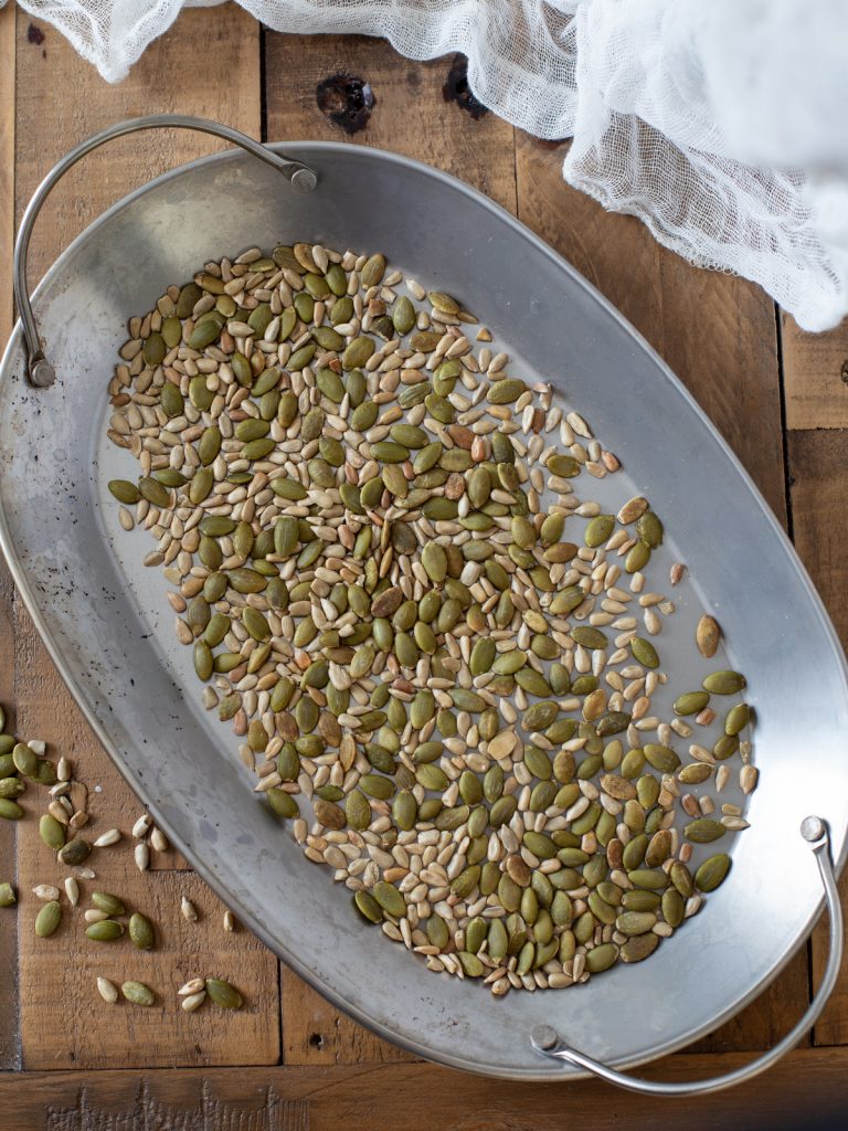Sunflower and pumpkin seeds roasted in a pan.