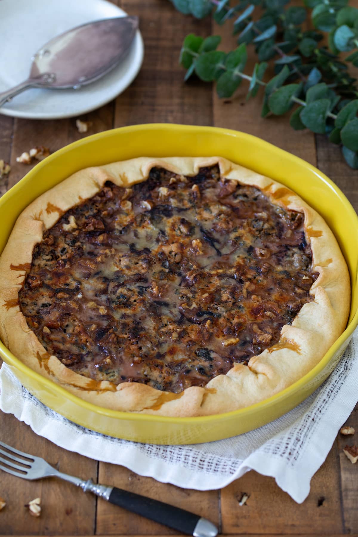 Radicchio and blue cheese quiche in a yellow ceramic pan.
