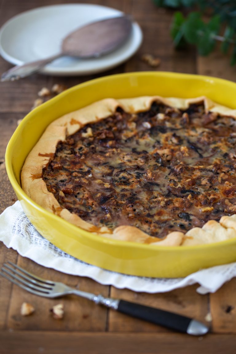 Radicchio quiche with walnuts in a ceramic tart pan.