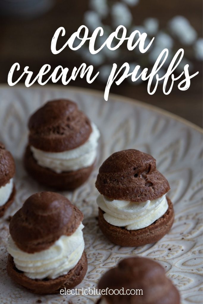 Homemade cocoa choux pastry buns filled with cream to make delicious chocolate cream puffs.