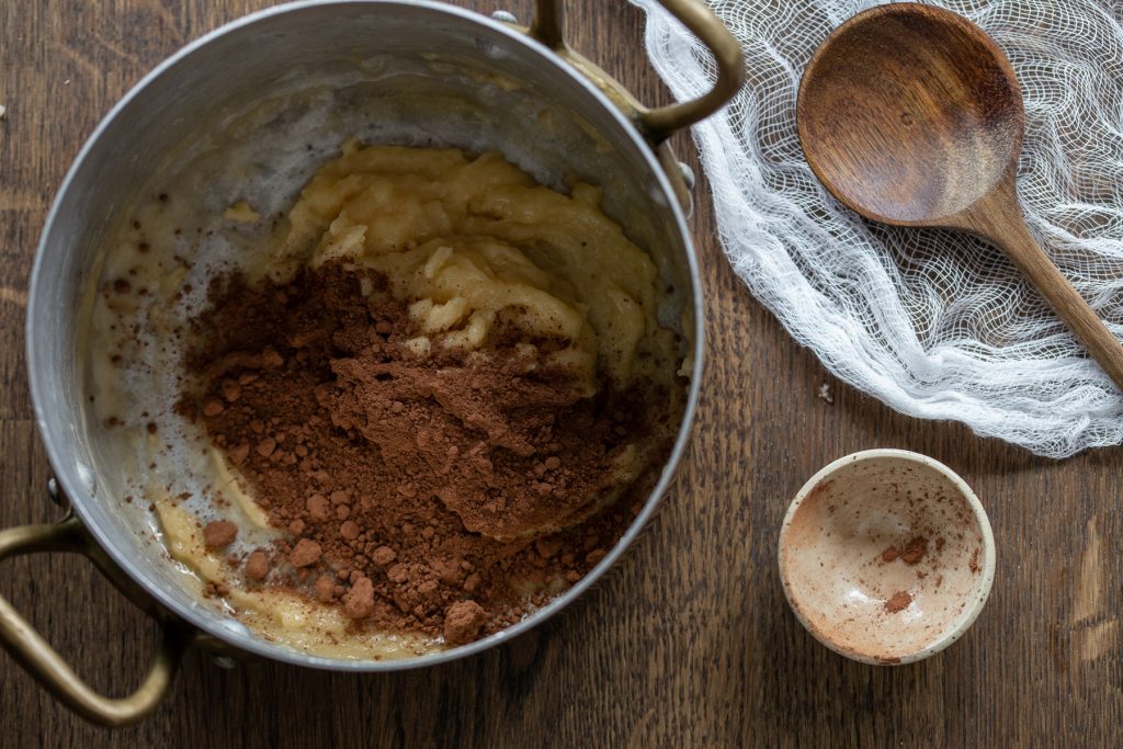 Adding cocoa to choux pastry dough.