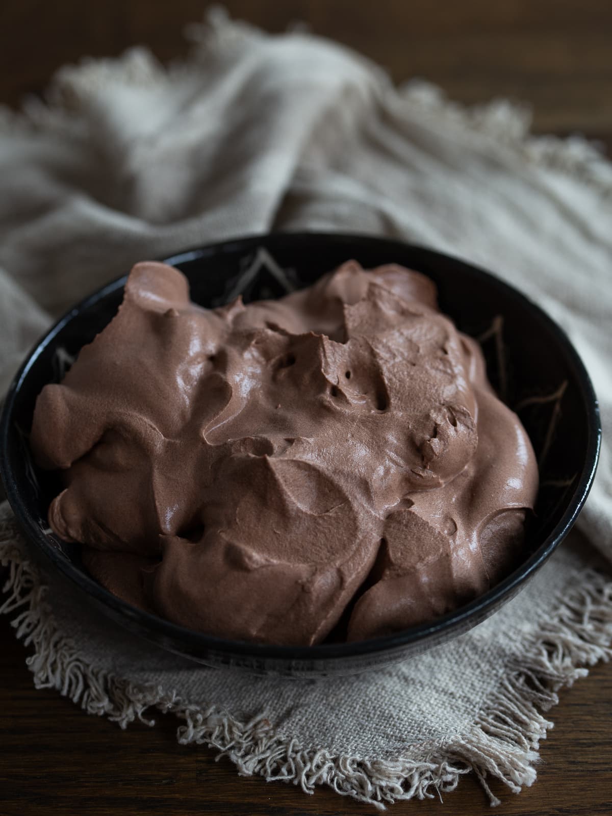 A batch of cocoa whipped cream in a black bowl.