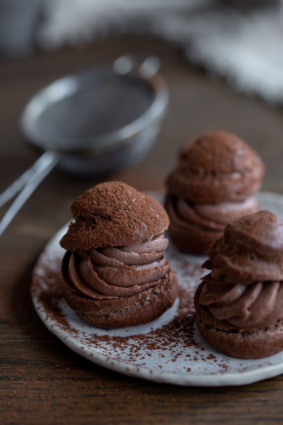 Cocoa cream puffs filled with chocolate frosting.