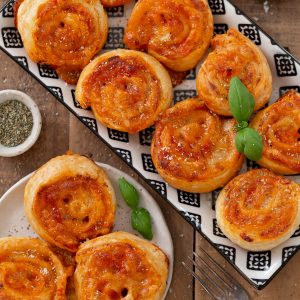 Puff pinwheels filled with tomato and mozzarella and topped with parmesan and oregano.