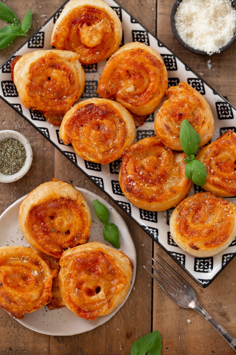 Puff pinwheels filled with tomato and mozzarella and topped with parmesan and oregano.