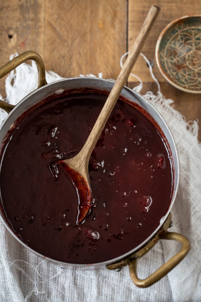 Plum jam in a copper pot.