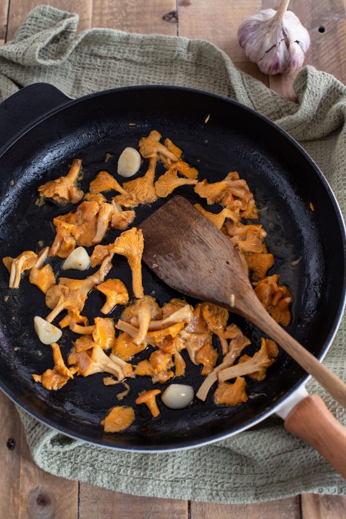 Sautéing chanterelles and garlic in butter.