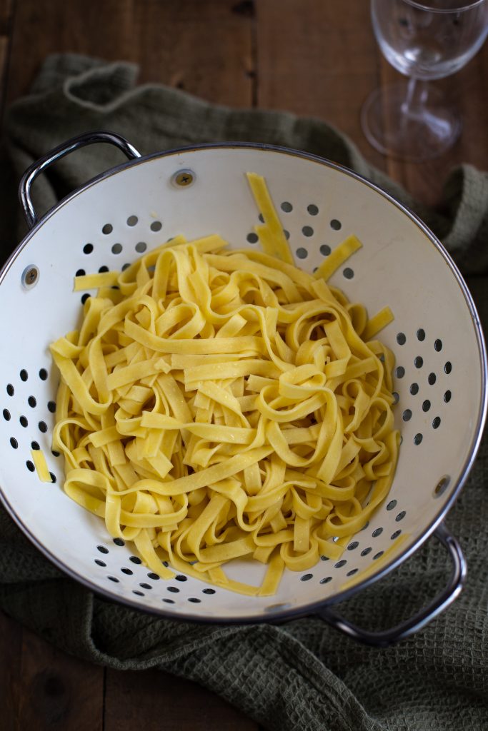 Tagliatelle in a colander.