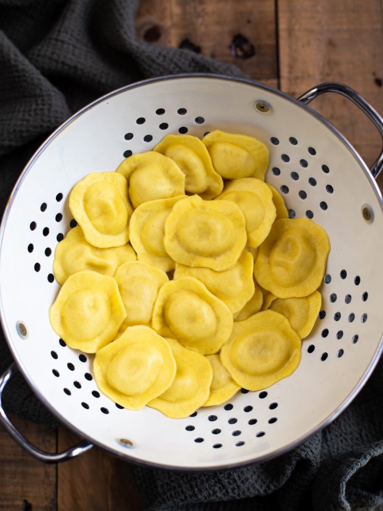 DRained ravioli in a colander.