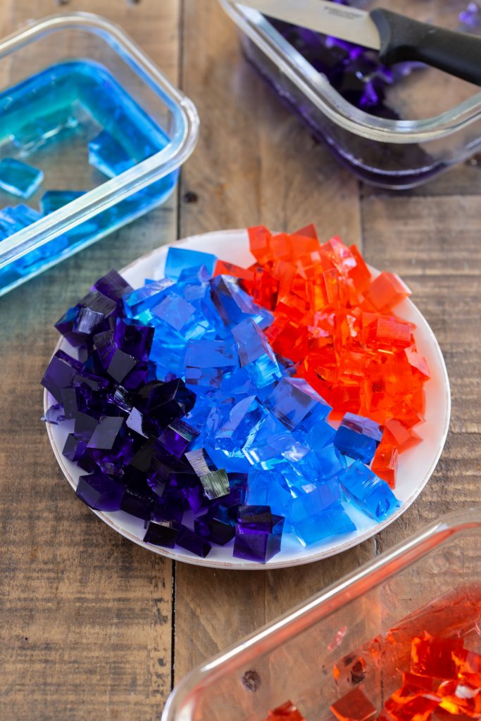Diced jello on a white plate.