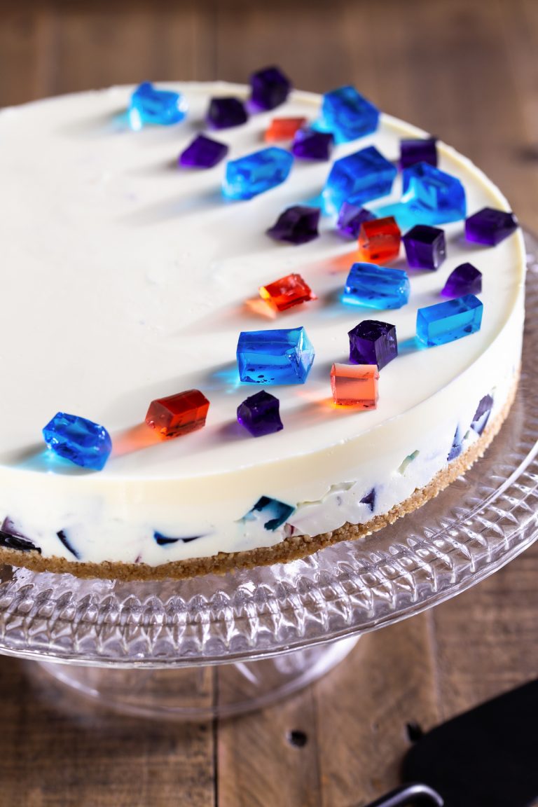 Cheesecake decorated with diced jello on top.