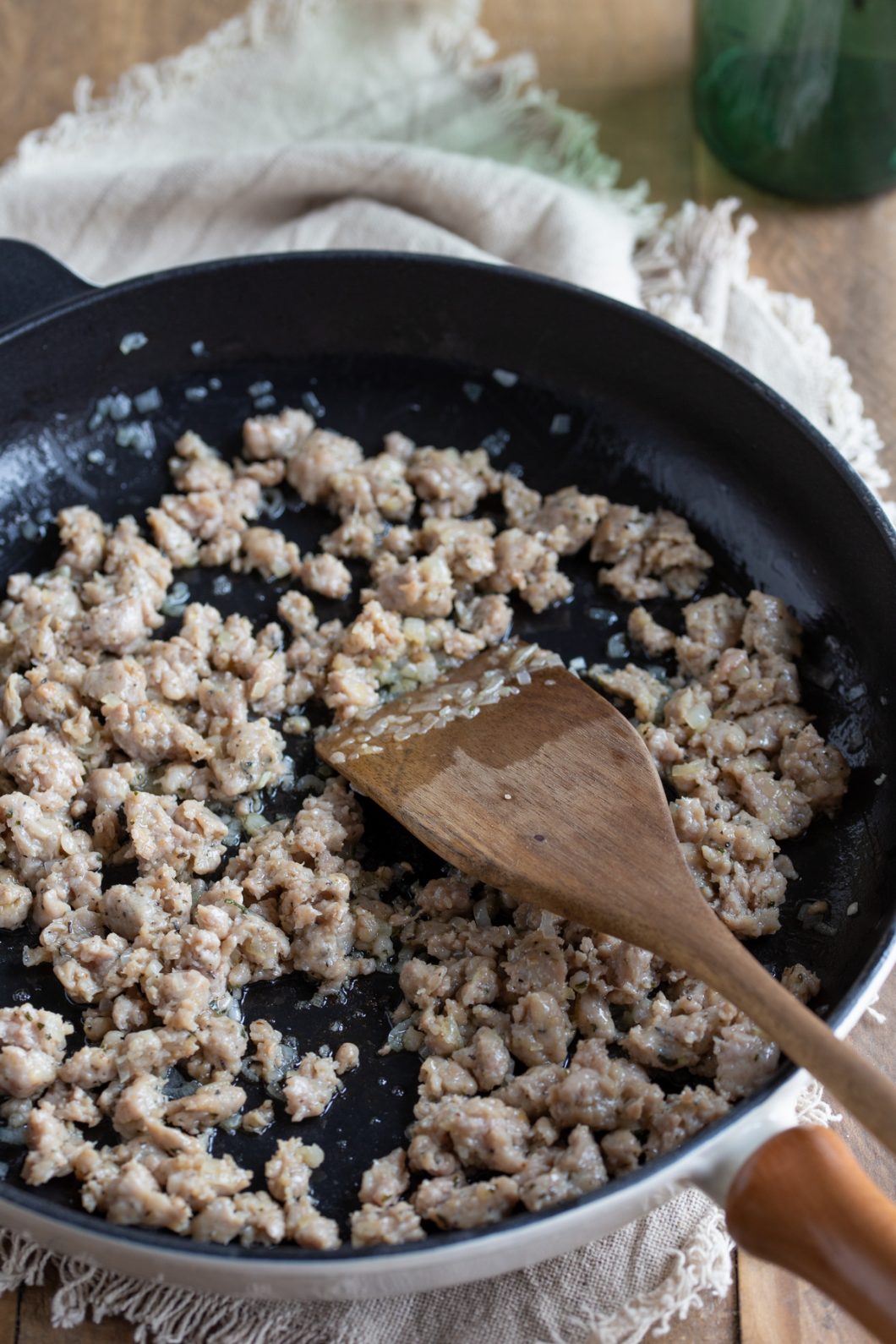 Sauté onion and sausage in a skillet.