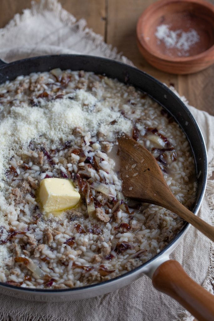 Folding in the butter and grated parmesan.