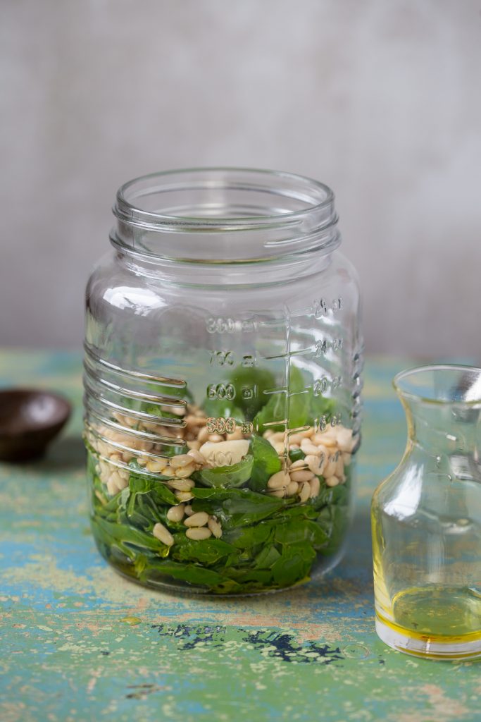 Pesto ingredients added to the jar.
