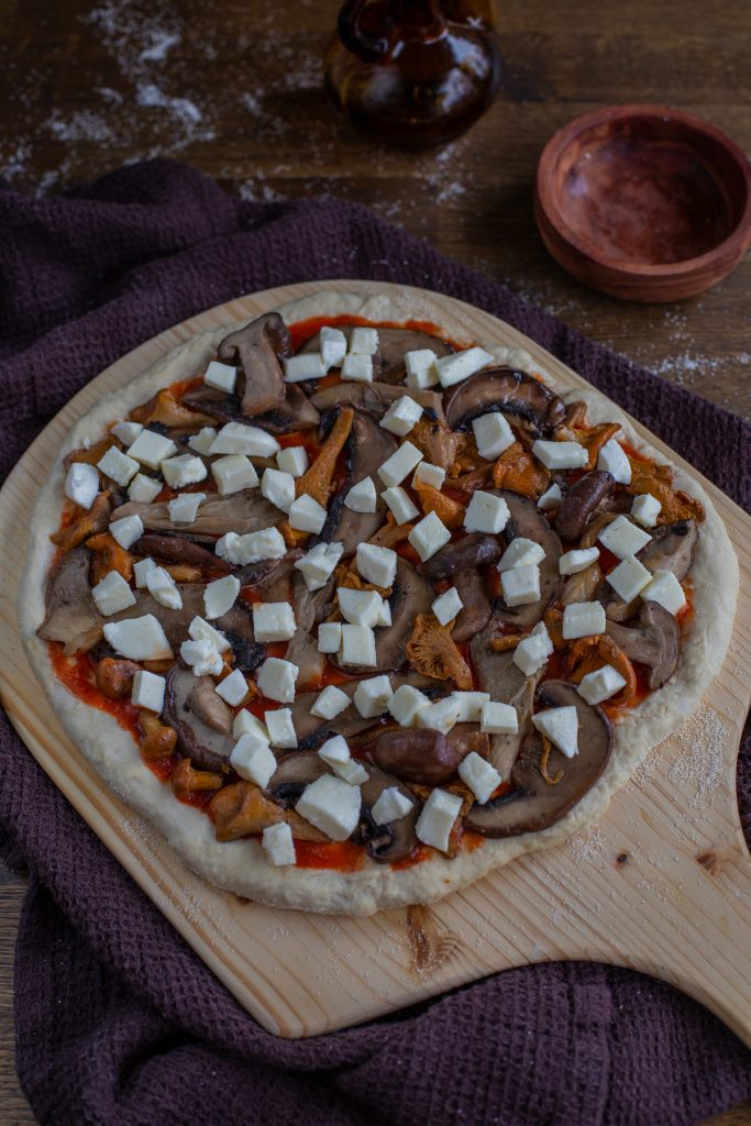 Topping with mozzarella.