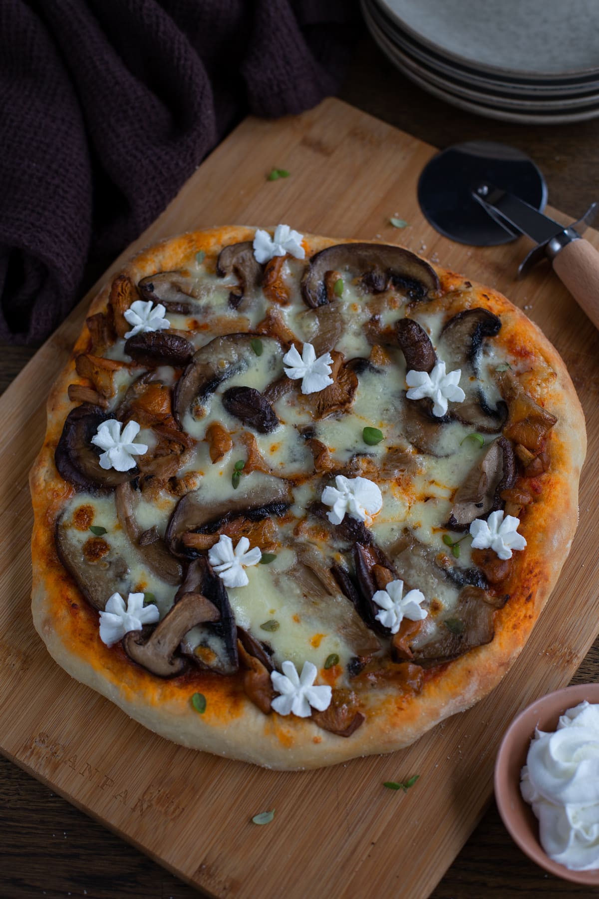Mixed mushroom pizza topped with goat cheese.