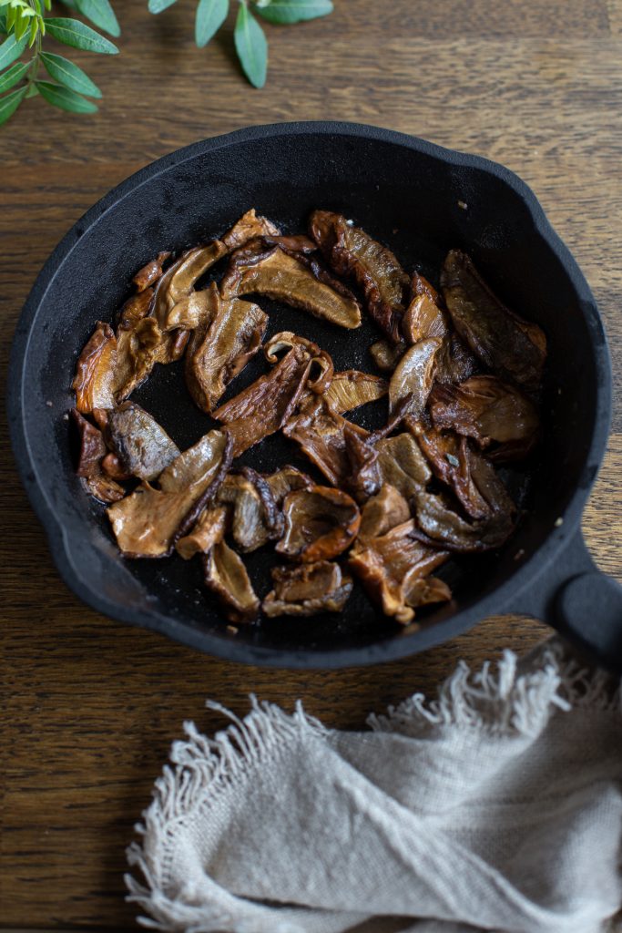 Sautéed porcini in a small cast iron skillet.