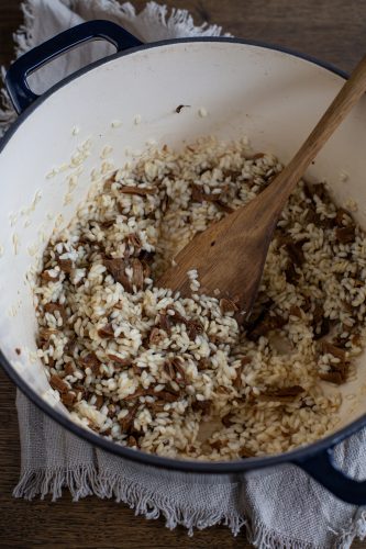 Preparation of risotto with chopped porcini.
