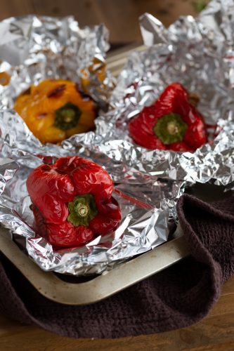 Roasted bell peppers in aluminium foil.