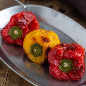 Oven-roasted bell peppers on a metal serving plate.
