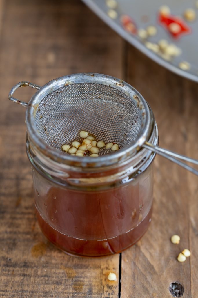 Separating the seeds from the juices.